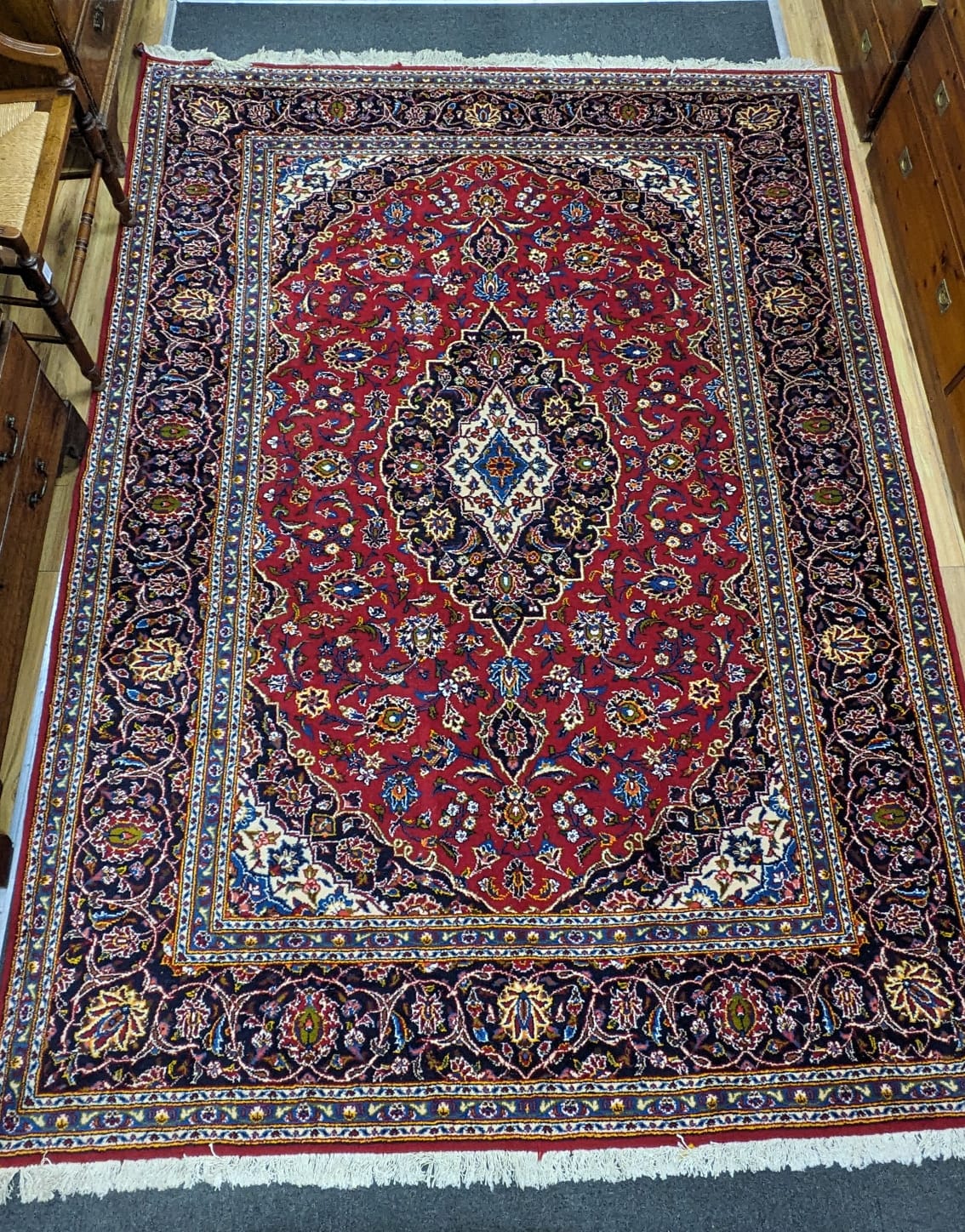 A Tabriz burgundy ground carpet, 292 x 216cm